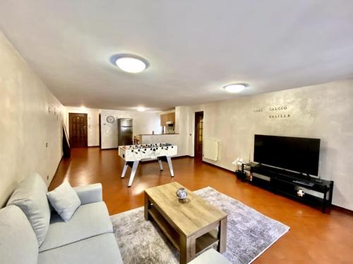 a living room with a couch and a table at CENTRO STORICO casa calcio balilla in Aosta