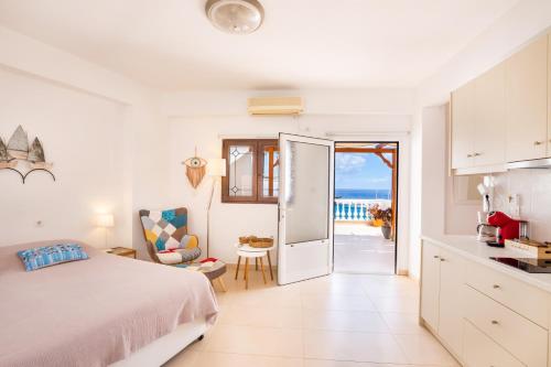 a bedroom with a bed and a view of the ocean at Mimis & Connie 2 in Karpathos Town