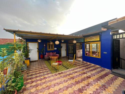 a house with a blue wall and a patio at Riad dar sahrawi in Marrakech