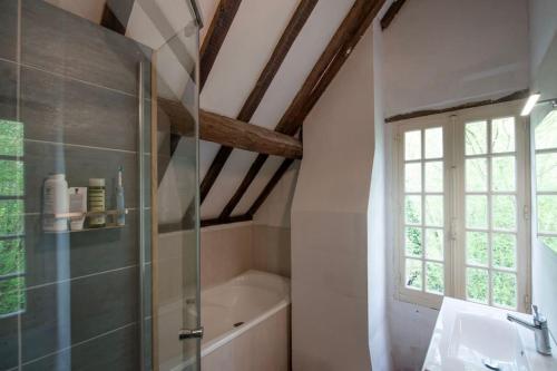 une salle de bain avec une douche, une baignoire et un lavabo dans l'établissement Huis op een eiland in de Loire, à Gennes