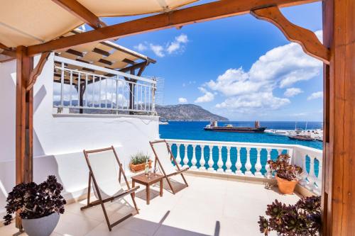 a balcony with chairs and a view of the ocean at Mimis & Connie 2 in Karpathos Town
