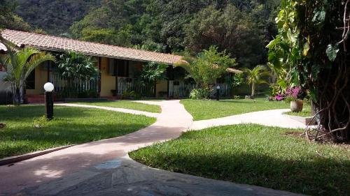 a walkway in front of a house at Embaúbas suíte privativa in Serra do Cipo