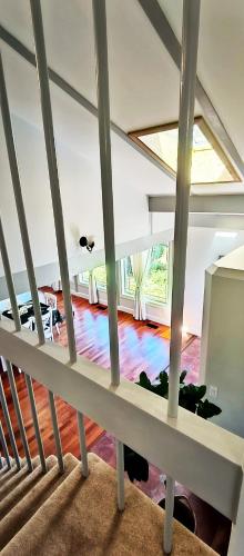 a view of the living room from the stairs of a house at White House Tofino Downtown Villa in Tofino