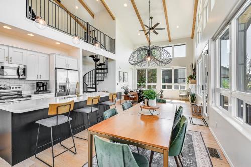 a kitchen and living room with a table and chairs at Views and Hot Tub Pineberry Modern Luxury Home in Pine