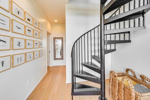 a spiral staircase in a hallway with art on the wall at Views and Hot Tub Pineberry Modern Luxury Home in Pine
