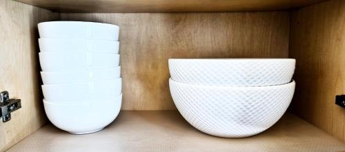 two white bowls are sitting on a shelf at White House Tofino Downtown Villa in Tofino