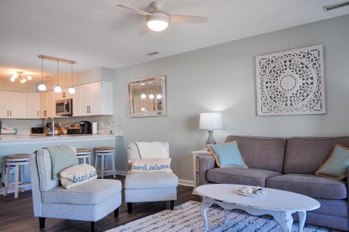 a living room with a couch and chairs and a table at Doves Landing in Surf City