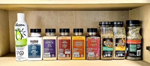 a shelf with spices and other items on it at White House Tofino Downtown Villa in Tofino