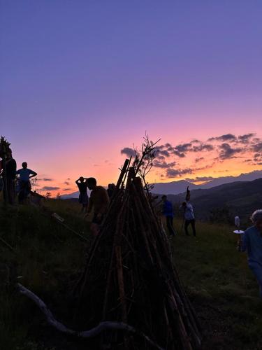 a group of people standing on a hill with a pile of sticks at Casa Costa Laspaúles in Laspaúles