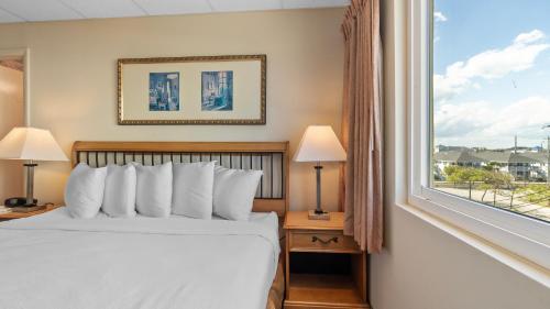 a bedroom with a bed and a large window at Safari Hotel Boardwalk in Ocean City
