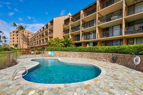 a swimming pool in front of a building at New! Maalaea Banyans 204 - Expansive Ocean Views! in Wailuku