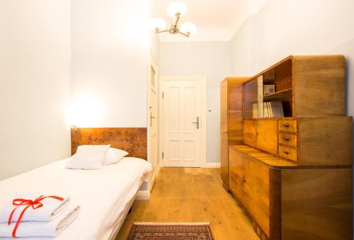 a bedroom with a bed and a book shelf at Chopin Boutique in Warsaw