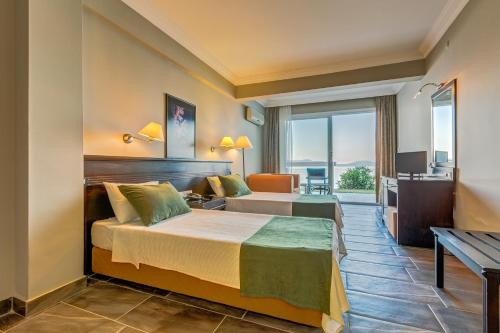 a hotel room with a bed and a desk at Cunda Hotel in Ayvalık