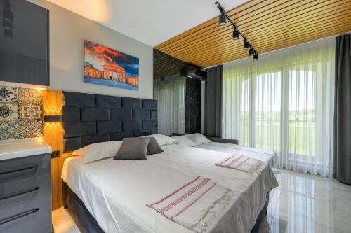a bedroom with two beds and a television in it at Azur Properties 74 in Shkorpilovtsi