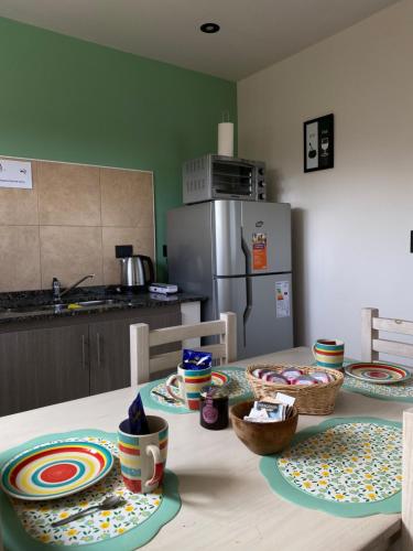 a kitchen with a table with plates on it at Departamentos Limay in Dina Huapi