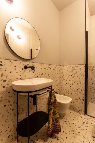 a bathroom with a sink and a mirror at Residenza San Longino in Mantova