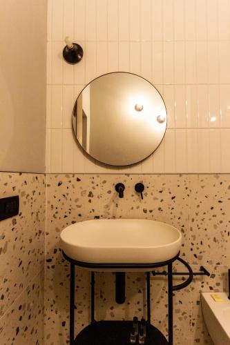 a bathroom with a sink and a mirror on the wall at Residenza San Longino in Mantova