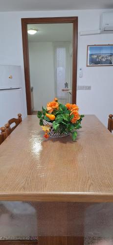 a vase of orange flowers sitting on top of a table at casa al mare kalispera in Marina di Mancaversa