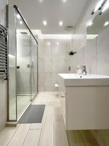 a bathroom with a sink and a shower at Trigon Palace in Budapest