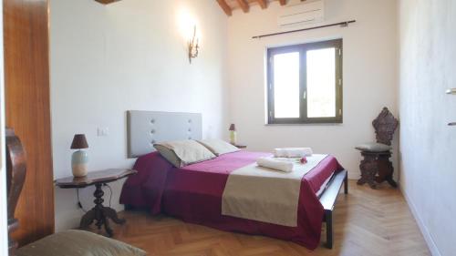 a bedroom with a bed and a window at Capalbio - Retreat in Capalbio