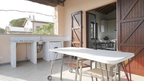 a kitchen with a white table and a window at Capalbio - Retreat in Capalbio