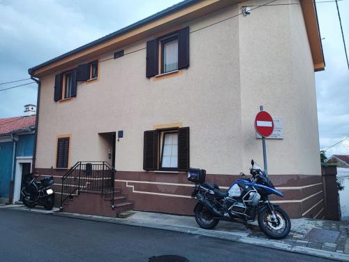 a motorcycle parked next to a building with a stop sign at City apartment Rina in Crikvenica