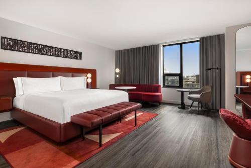 a hotel room with a bed and a desk at Revery Toronto Downtown, Curio Collection by Hilton in Toronto