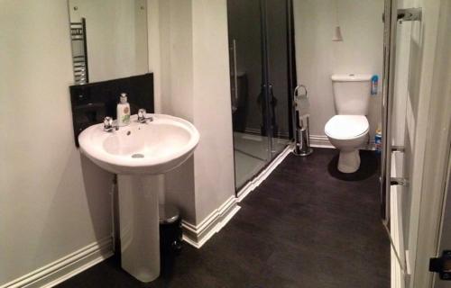 a bathroom with a sink and a toilet at Taff Trail Bunkhouse in Merthyr Tydfil