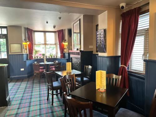 a dining room with tables and chairs in a restaurant at The Prince Albert Pub & Hotel with onsite FREE PARKING 2 minutes from Legoland in Windsor