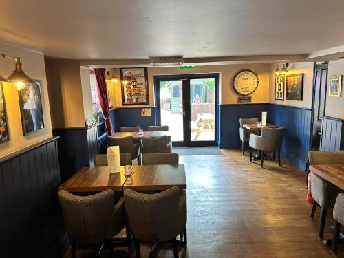 a dining room with tables and chairs in a restaurant at The Prince Albert Pub & Hotel with onsite FREE PARKING 2 minutes from Legoland in Windsor