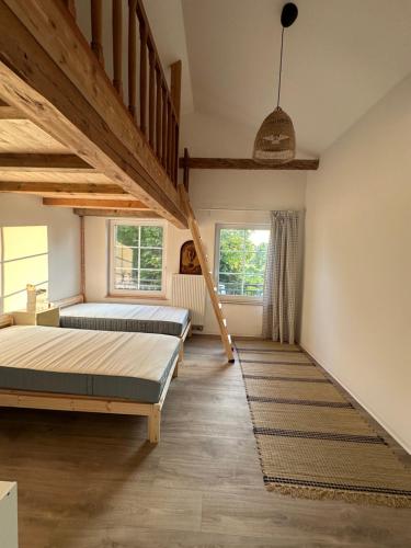 two beds in a room with wooden beams at Zum Singschwan in Rieseby