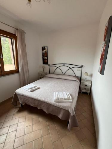 Un dormitorio con una cama con dos toallas encima. en Villetta Zuccale III Natura e Vista Mozzafiato sul Mare, en Capoliveri