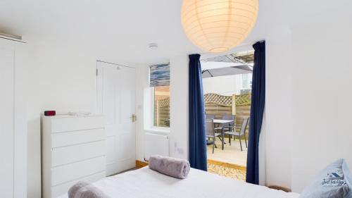 a bedroom with a bed and a window and a table at East View, a stunning home from home in St Helens, sleeps 6. in Saint Helens