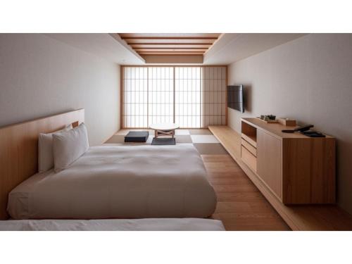 a hotel room with a bed and a television at SOKI ATAMI - Vacation STAY 93416v in Atami