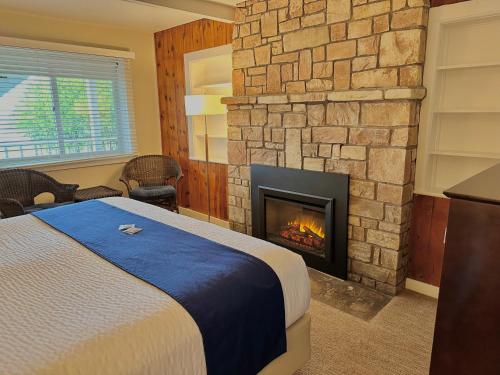 a bedroom with a bed and a fireplace at The Water Street Inn in Ephraim