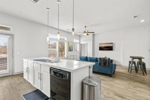 a kitchen and living room with a blue couch at LUX 2B2B with Pool & Parking near the Heart of Austin in Austin