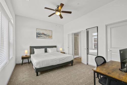 a bedroom with a bed and a ceiling fan at LUX 2B2B with Pool & Parking near the Heart of Austin in Austin