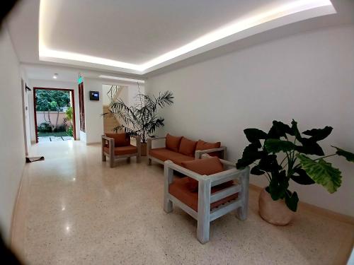 a living room with a couch and a plant at Sandbox Apartment 4 Diani Beach Kenya in Ukunda