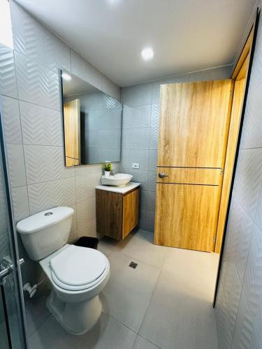 a bathroom with a toilet and a sink at Aero Hotel Boutique in Bogotá