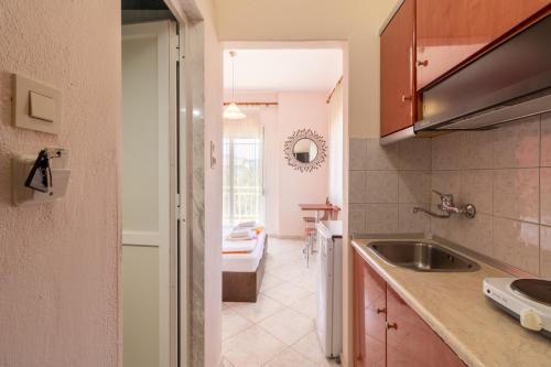 a kitchen with a sink and a counter top at Iliadis House in Sarti