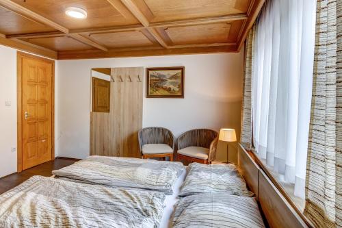 two beds in a room with a window at Ludwighaus in Neukirchen am Großvenediger