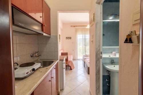 a kitchen with a sink and a counter top at Iliadis House in Sarti