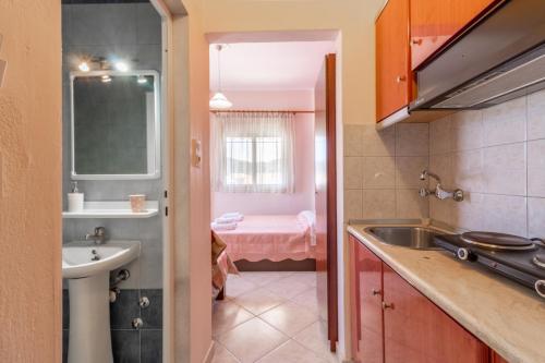 a small kitchen with a sink and a bathroom at Iliadis House in Sarti