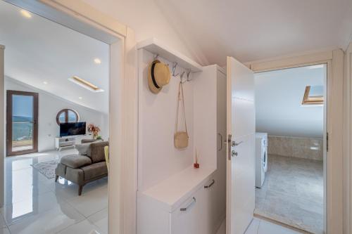 a white hallway with a living room and a couch at Blue View Suites Kaş in Kas