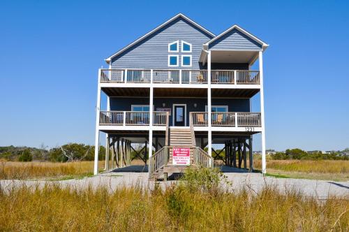 a large house on the beach with a boardwalk at Family Tides North Topsail Beach in North Topsail Beach