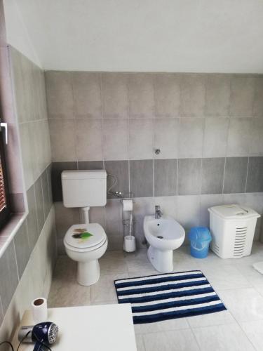 a bathroom with a toilet and a bidet at Apartman Brazil in Bihać