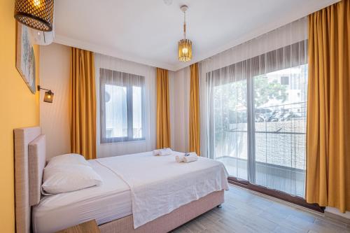a bedroom with a bed and a large window at Blue View Suites Kaş in Kas