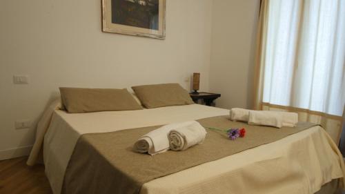 a bedroom with a bed with towels on it at Capalbio - Retreat in Capalbio