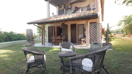 a group of chairs sitting in the yard of a house at Capalbio - Retreat in Capalbio