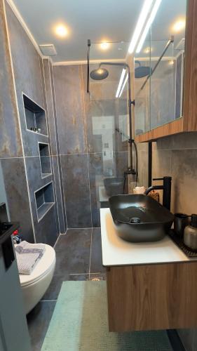 a bathroom with a black sink and a shower at George luxury living in Preveza